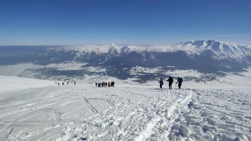 Mountaineers hiking on a winter sunny day to reach the mountain peak