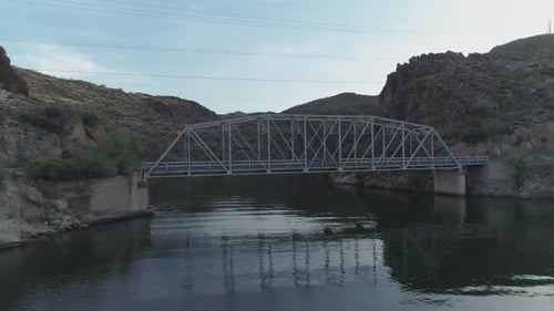 AERIAL - Drone Goes Under Bridge to Reveal Desert Lake (Canyon Lake)