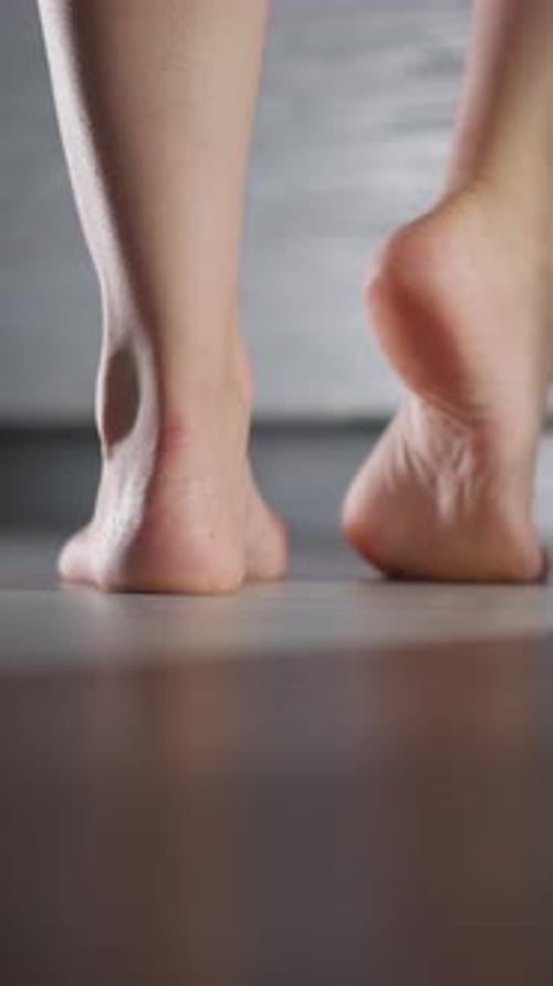 Barefoot Woman Stands in Bathroom Doorway
