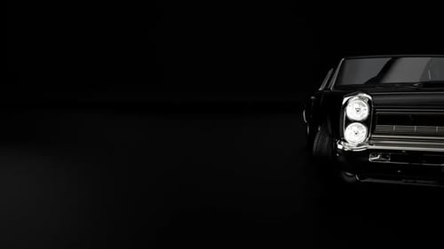 Sleek black car against dark background