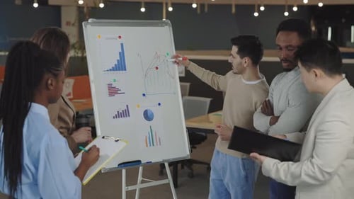 Diverse Team Analyzing Data Together in Office