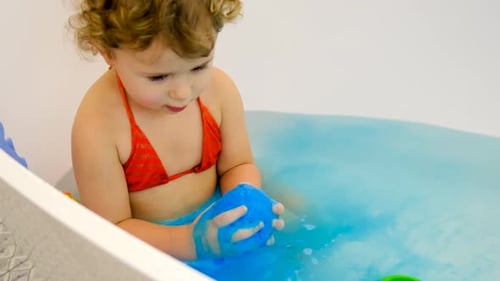 The Child Bathes in the Bath Paint Blue Color