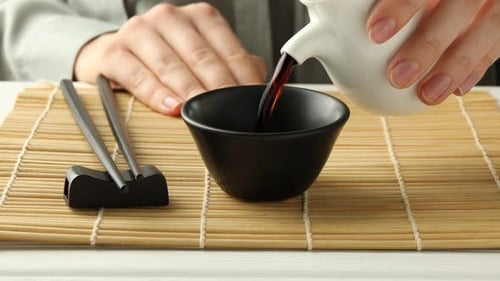Soy Sauce Poured into Bowl with Chopsticks