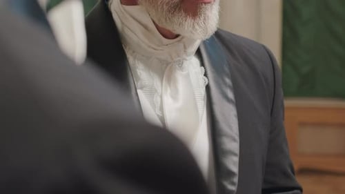 Man Conversing in Black Suit and Hat