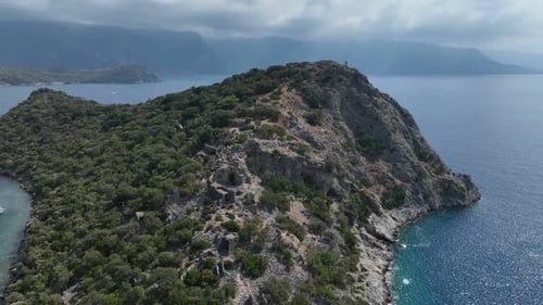 Scenic view of tropical beach with green hill backdrop.