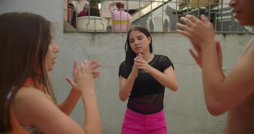 Children clapping hands in courtyard, unison rhythm, bright smiles, carefree connection,