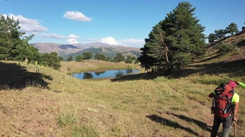 Aerial View Of Two Hiking Men Chatting By Lake