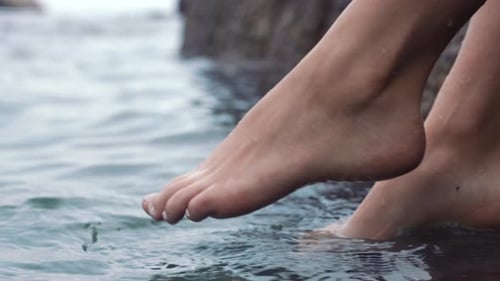 Feet of woman, dip in ocean or sea on vacation, trip or summer holiday