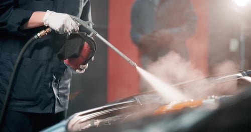 Mechanic, hands and pressure wash car in garage for deep cleaning, fixing preparation