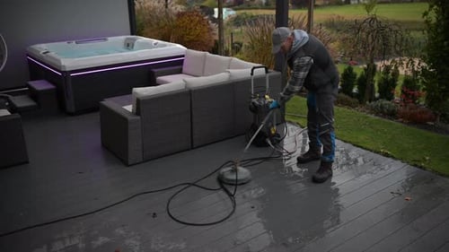 Pressure Washer Cleaning Patio Area With Pressure Washer in Autumn