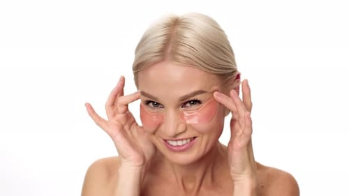 Woman Applying Eye Patches for Skin Care