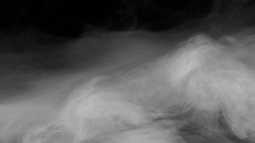 Drifting White Smoke Against Black Background