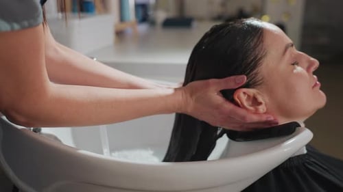 Woman Receiving Hair Wash at Salon Spa