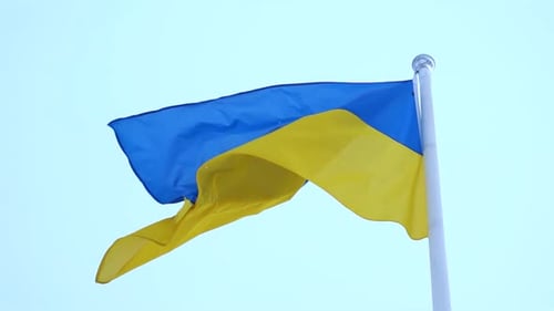 Waving Ukrainian Flag Against a Clear Blue Sky