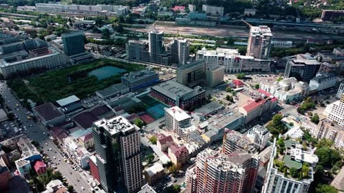 The capital of Ukraine from bird's eye. Flying high above Kyiv city streets near city center. Busy t