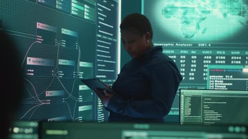 Woman Analyzing Data on Futuristic Monitor Wall