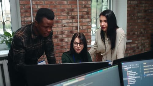 Team of Designers or ITspecialists Discussing in Office Black Man and Two Caucasian Women