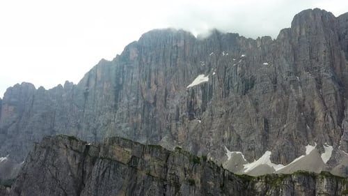 Aerial close up of a mountain ridge on a cloudy overcast day in the Dolomites Italy near Alleghe vil