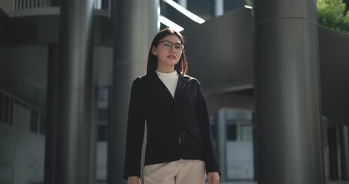 Confident Young Woman in Business Attire Stands Outdoors