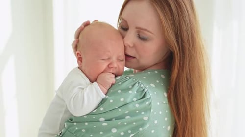 Mother Holding Baby Comforting Crying Infant