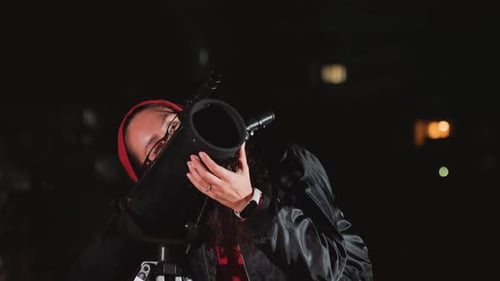 Operator Calibrates Telescope Amid City Lights Bearded Technician Calibrates Astronomical Device