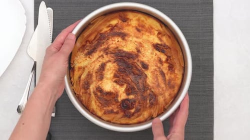 Hands Hold Freshly Baked Pie in Round Silver Pan