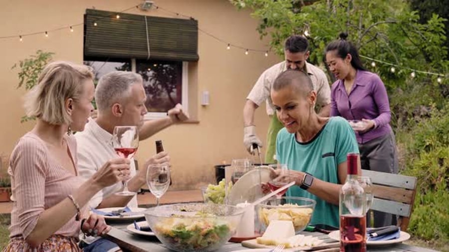 Cover for Middle Aged People Having Dinner and Fun Drinking Red Wine Together at Home Garden