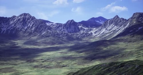 Majestic Mountain Range with Lush Greenery Under a Clear Blue Sky