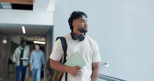 Tablet, college and man in hallway walking for learning, education or knowledge