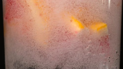 Citrus Slices Swirling in Sparkling Water Close-Up