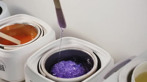 Depilatory Master Stirs Granular Wax Melter