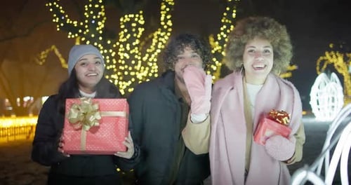 Excited Happy Friends Dancing and Having Fun on Garlands and Lights Background Outdoor New Year