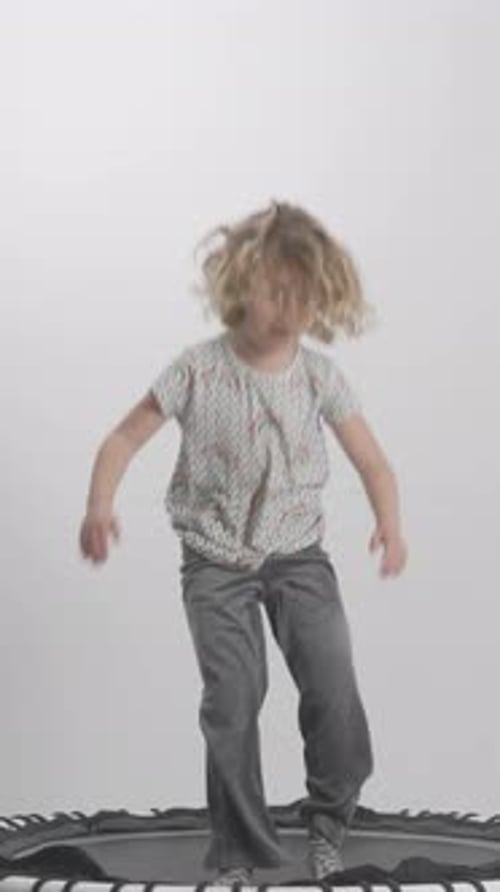 Happy Child Jumping on a Trampoline