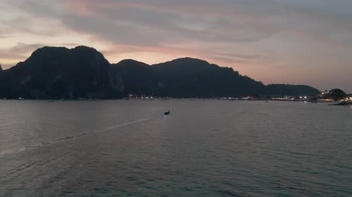 Drone aerial view of long tail boats during sunset in Koh Phi Phi