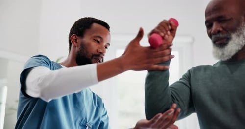 Therapist Assists Senior Man with Arm Exercises