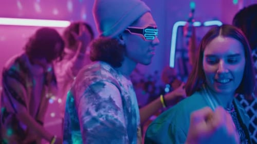 Young Adults Dancing at an Energetic Party