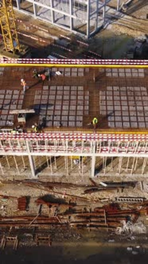 Vertical Video of Construction Workers in the Roof of New Building