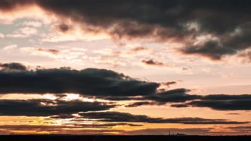 Dramatic Time Lapse of Golden Sunset Behind Clouds