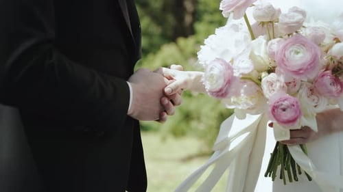 Close Up of Couple Holding Hands on Wedding Day