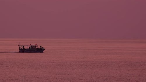 Silhouette of sea boat in dawn