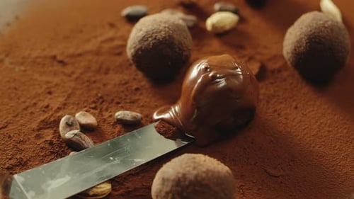Closeup Confectioner Hand Taking Truffle Chocolate With Spatula In Slow Motion. Truffle Candy Cov...