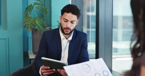 Business Meeting with Charts and Tablet in Office