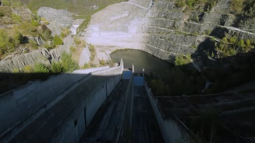 Establishing aerial of large dam in the mountains in spring. Hydroelectricity, industry