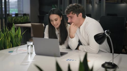 Cheerful Happy Smiling Office Colleagues Male Man Manager and Female Business Woman Sitting at Desk