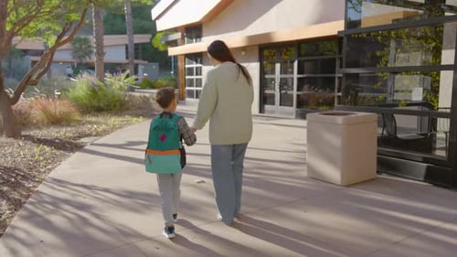A Parent and Child Walking to School Together Sharing Moments of Joy and Connection