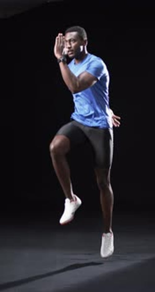 Athletic Man Performing High Knee Exercise