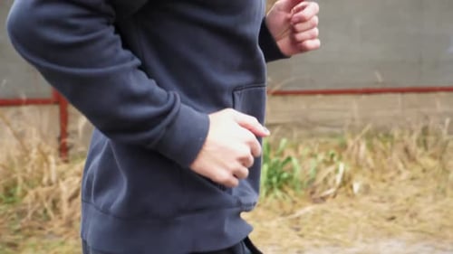 Athletic Sporty Man Running Along Country Road at Rainy Day Young Sportsman Jogging Along Rural