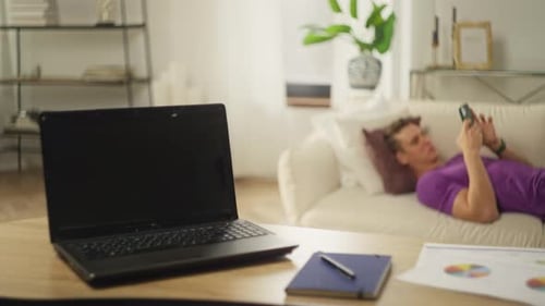 Young Adult Resting on Couch with Phone
