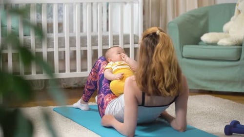 Mother and Baby Doing Leg Lifts Together