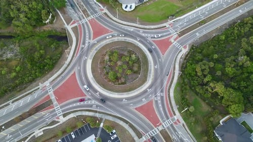 Top View of City Street Traffic on Roundabout Intersection with Moving Cars Viev From Above of Urban